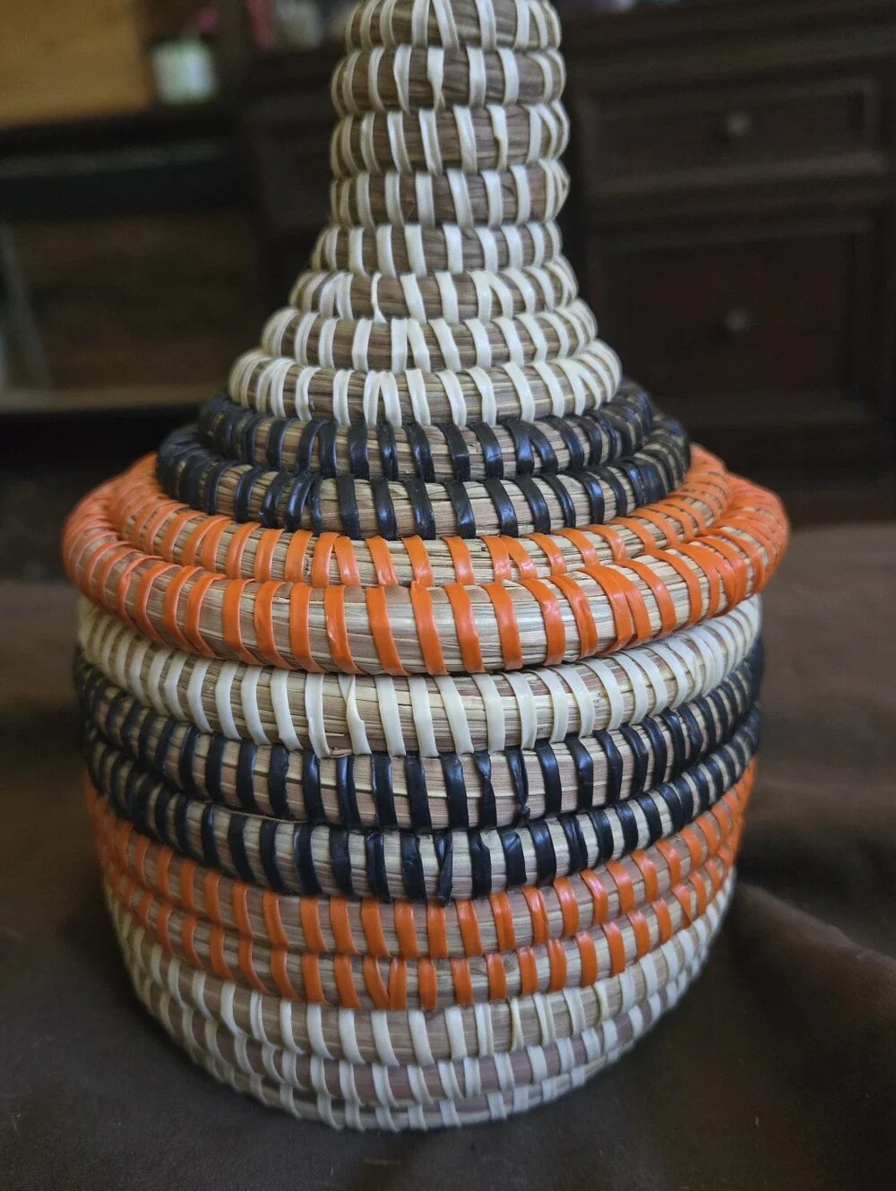 Handwoven Decorative Basket with Orange and Navy Accents